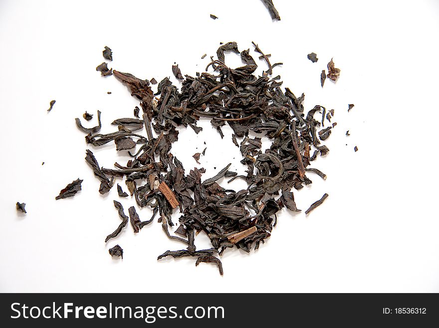 Dried black tea leaves on white background