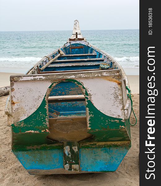 A crusty old fishing boat lying on a beach in Kerala. A crusty old fishing boat lying on a beach in Kerala.