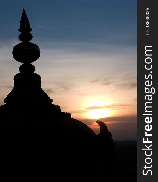 A temple dome silhouetted by the sunset.