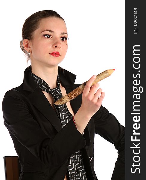 Girl in black suit looks at pencil. Isolated on white.