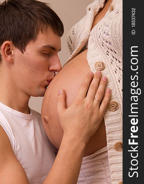 Man kisses belly of his pregnant wife. Man kisses belly of his pregnant wife