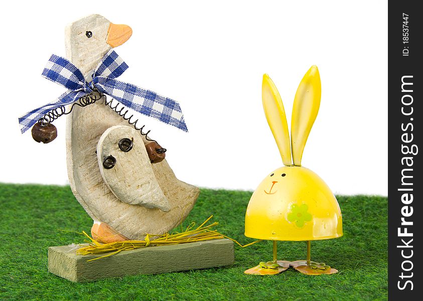 Easter goose and egg-shaped rabbit sitting on the grass. Easter goose and egg-shaped rabbit sitting on the grass
