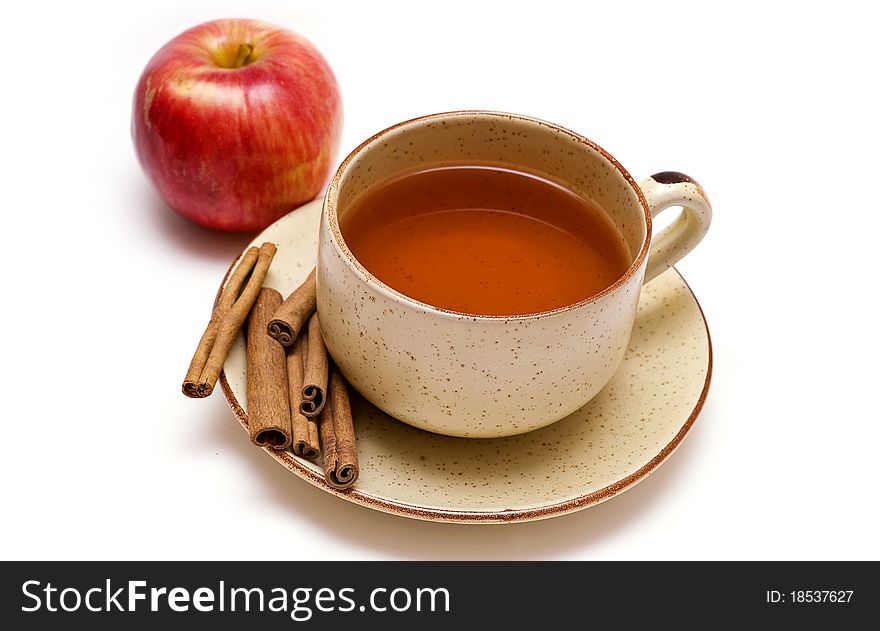 Cup of tea, cinnamon and apple on the white background
