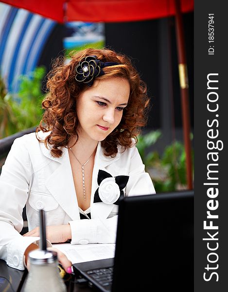 Young Woman In Cafe With Laptop