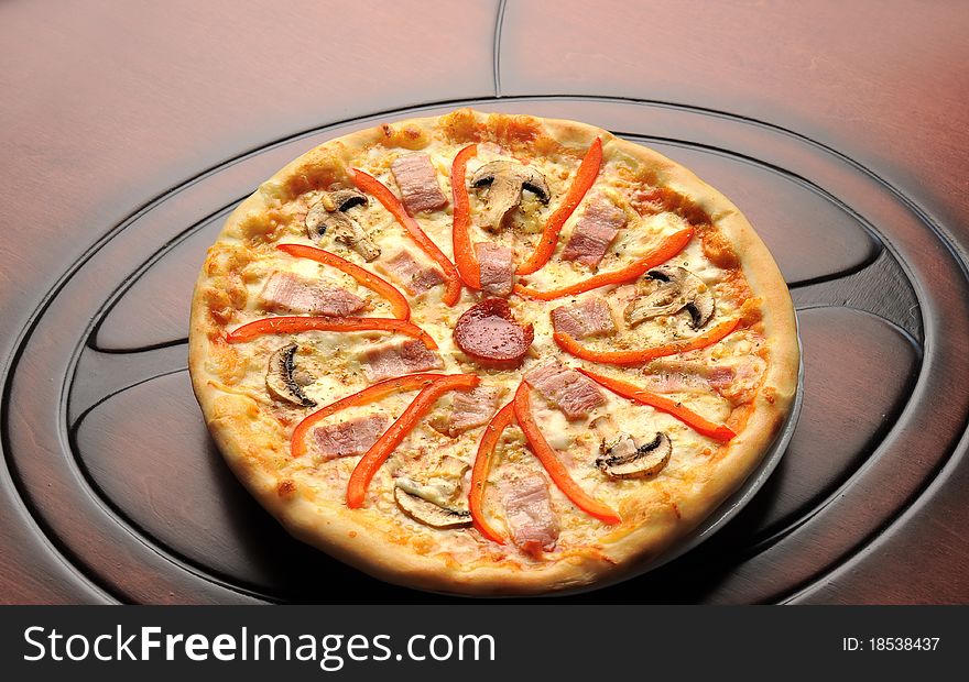 Italian round pizza with cheese, sausage and vegetables