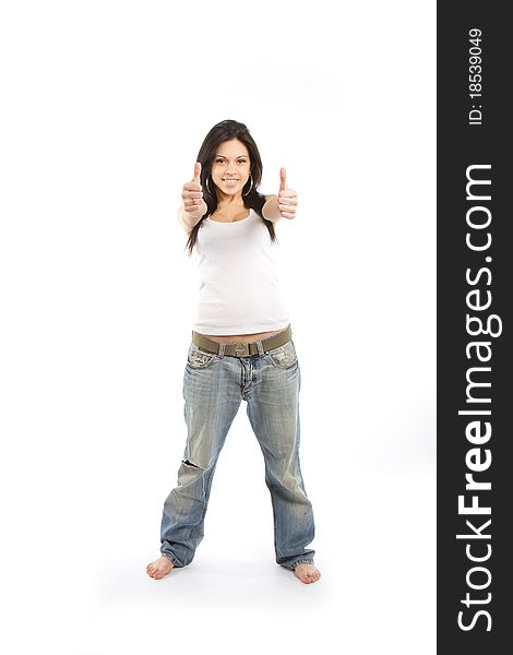 Portrait of an excited young woman gesturing a thumbs up sign against white background