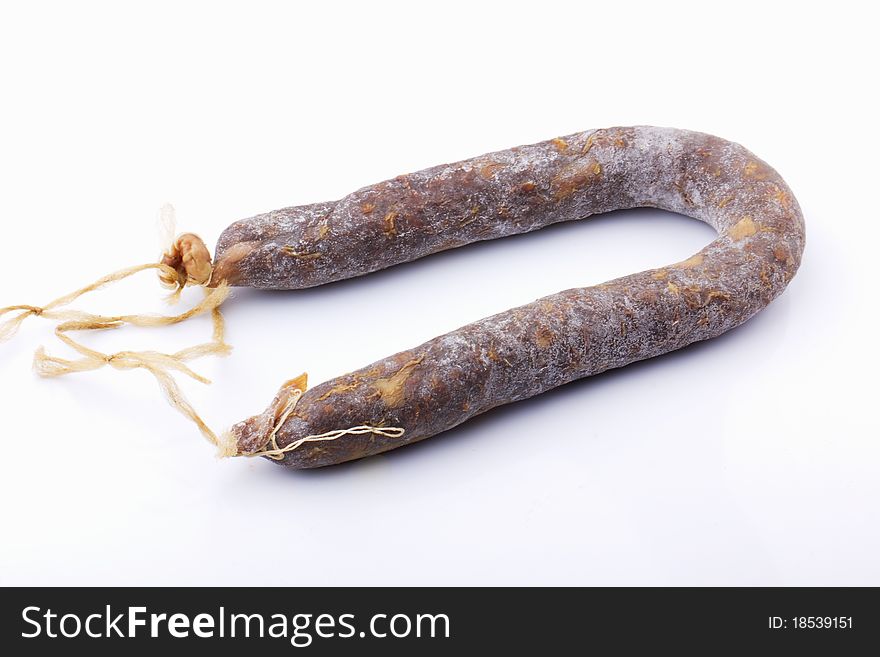 Raw sausage in red on a white background