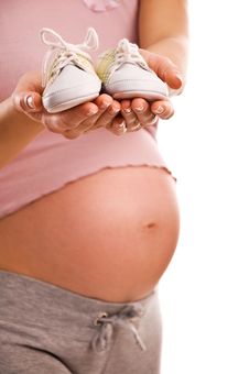 Pregnant Woman Holding Pair Of Shoes For Baby Stock Photography Pregnant Woman Holding Pair Of Shoes For Baby Stock Photography