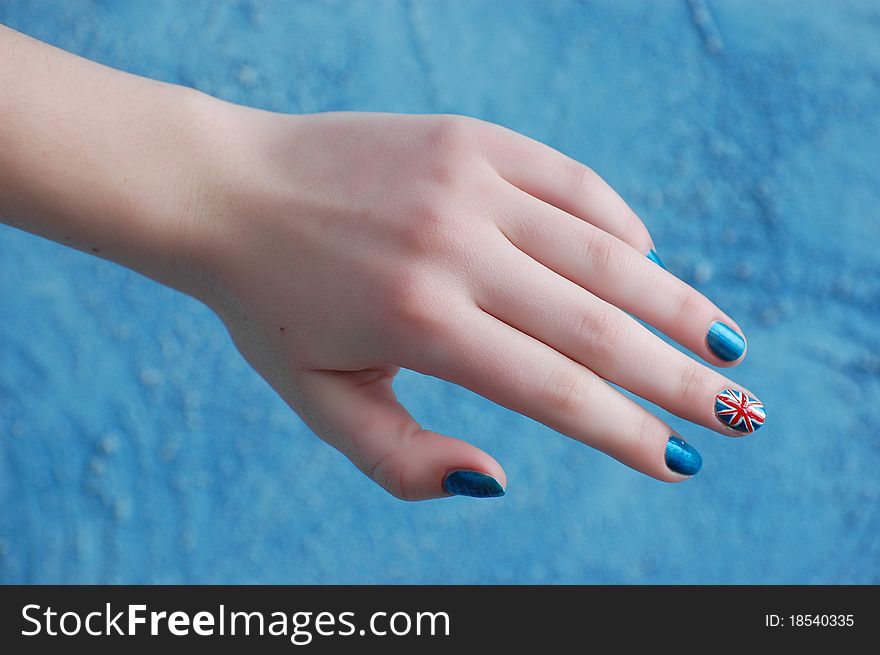 Hand with manicure in British Flag stile. Hand with manicure in British Flag stile