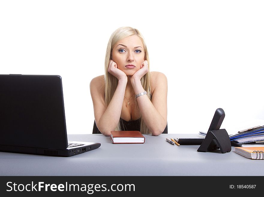 Sad businesswoman sitting at office desk, sadness. Isolated on white background. Sad businesswoman sitting at office desk, sadness. Isolated on white background