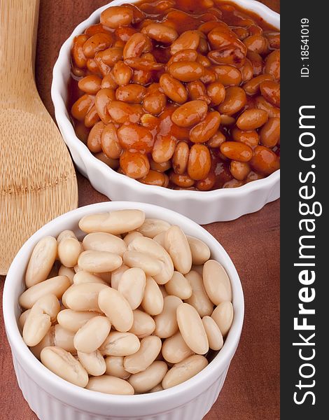 White canned beans in a white ceramic dish with red sauce. White canned beans in a white ceramic dish with red sauce.