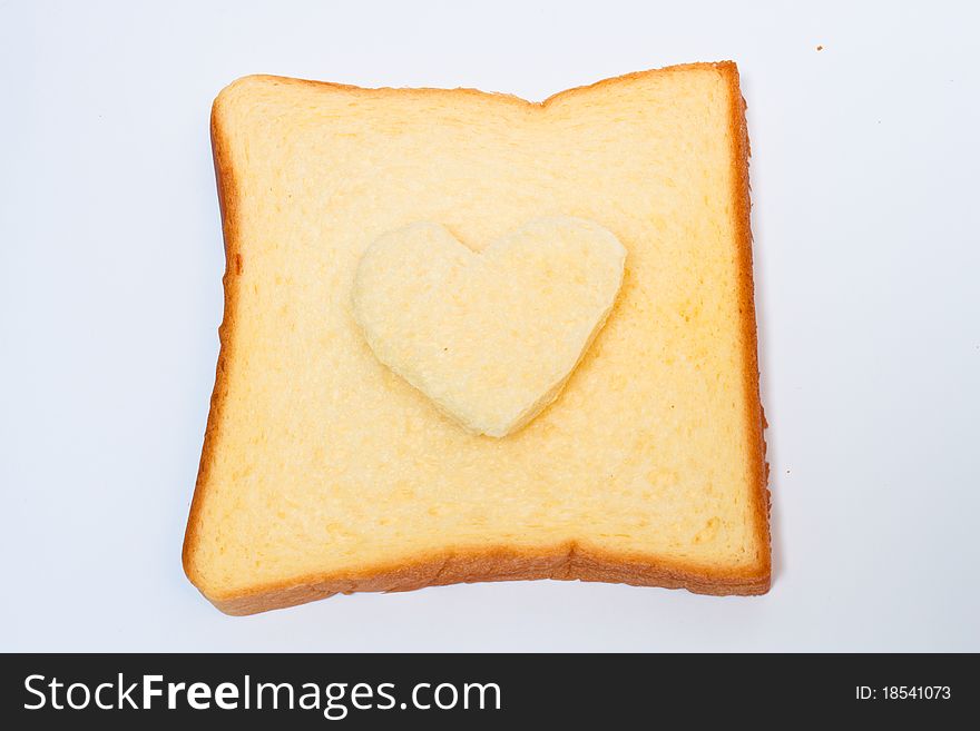 Slice bread with heart on white background