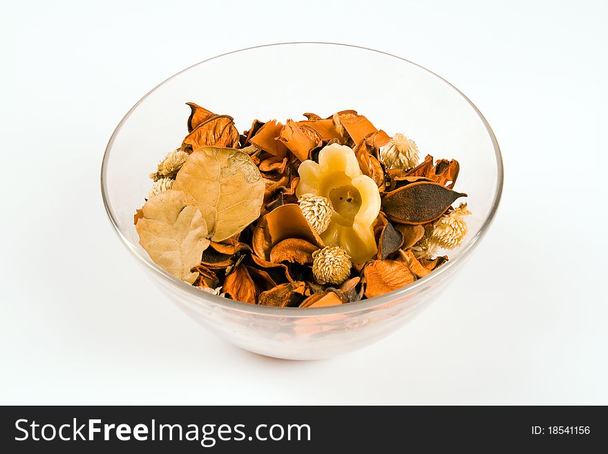 Brown potpourri in a transparent bowl isolated on white background. Brown potpourri in a transparent bowl isolated on white background