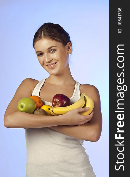 Young Beautiful Brunette Is Holding Fruit