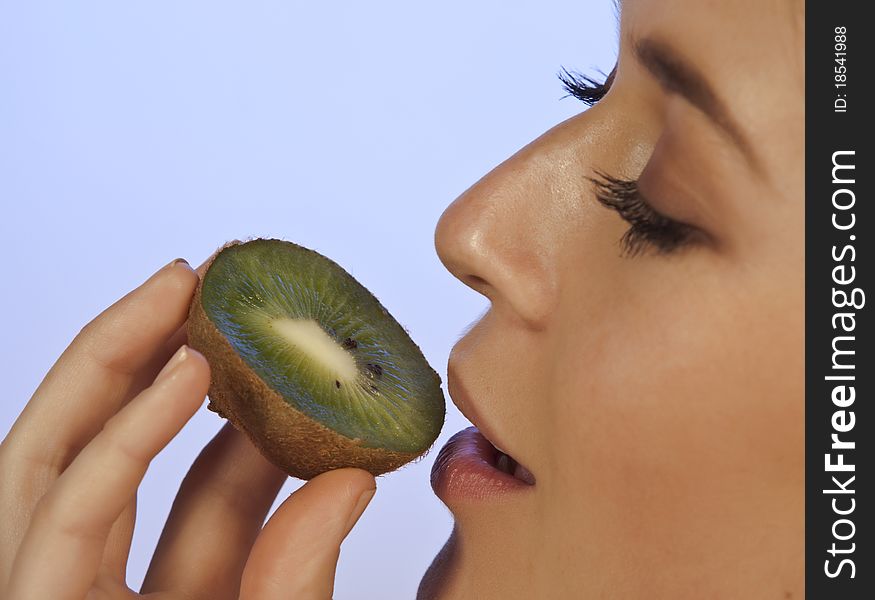 Young Woman Enjoying A Slice Of Kiwi