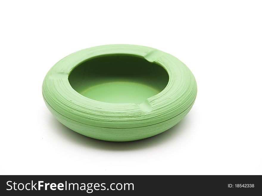 Green ashtray from ceramics onto white background