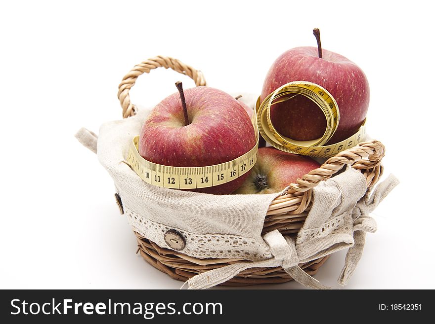 Red apples in the basket with tape measure. Red apples in the basket with tape measure