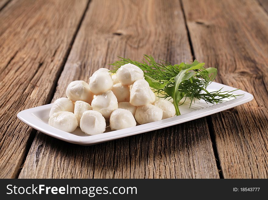 Fresh mozzarella cheese balls on a platter