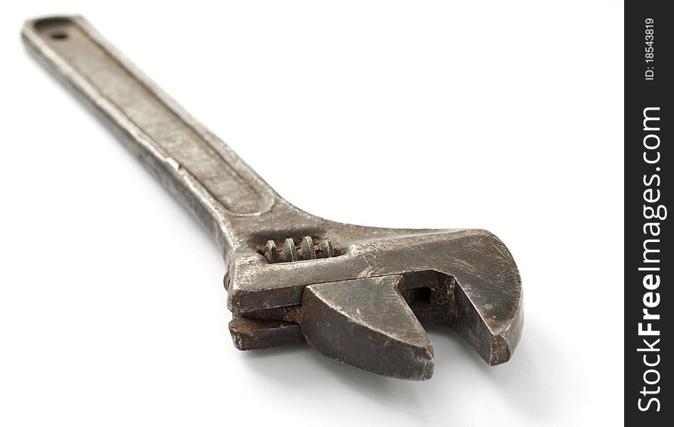 Old wrench on a white background, close-up.