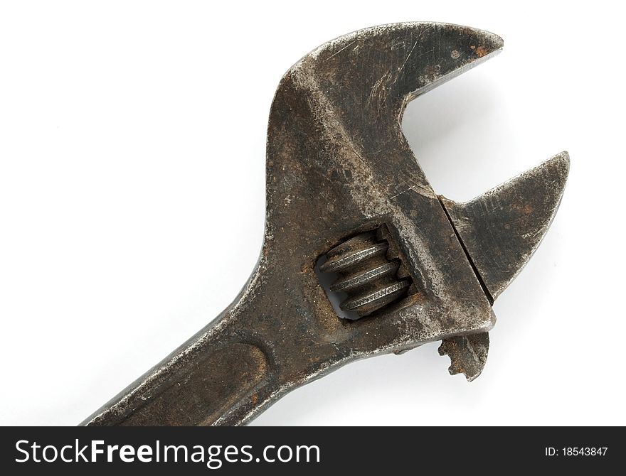 Old wrench on a white background, close-up.