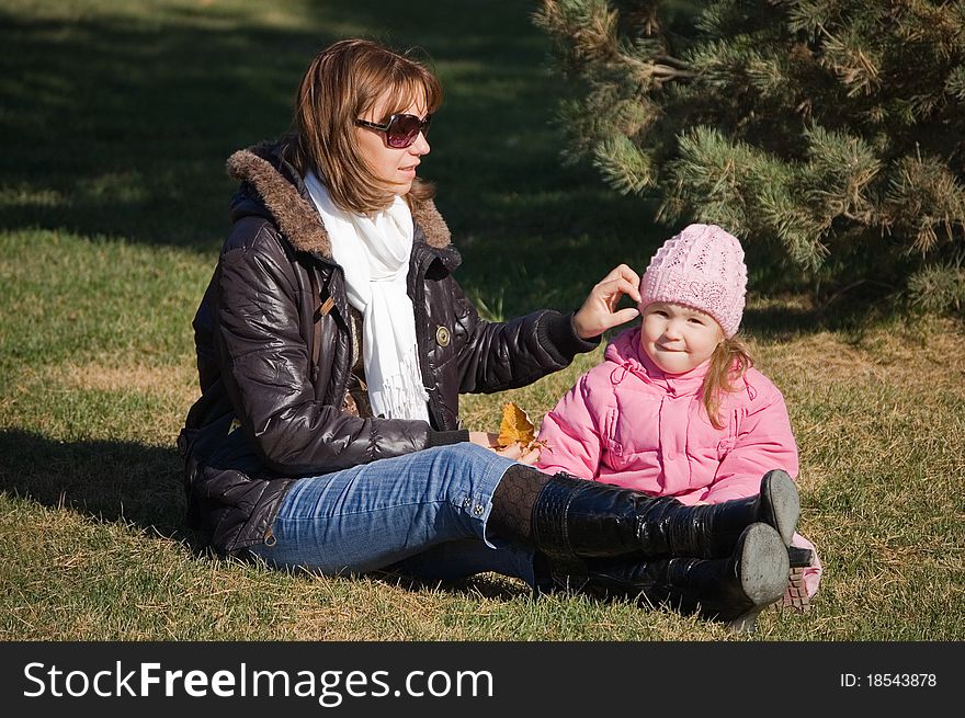 Mum With A Daughter In Autumn Park