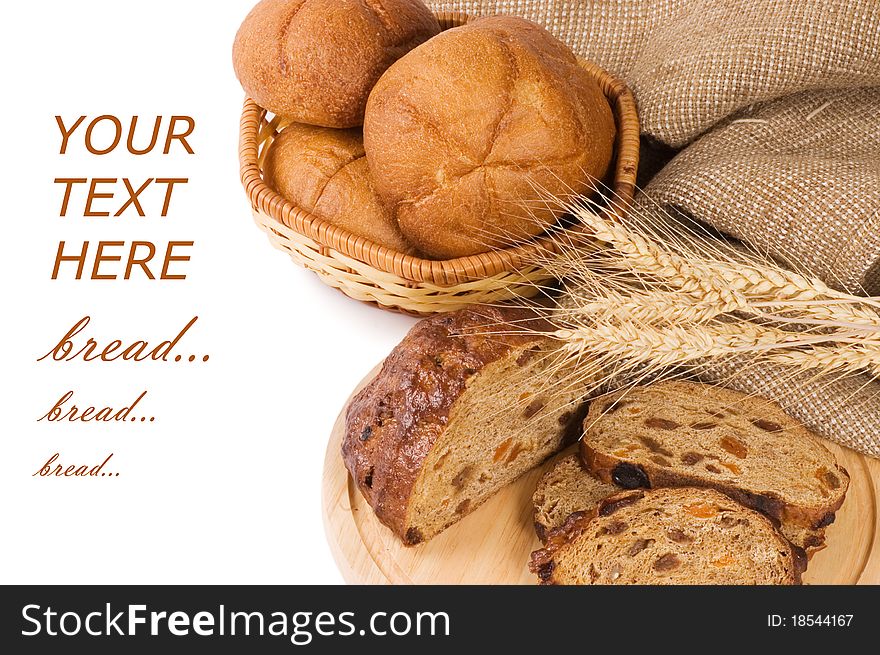 Fresh bread with ear of wheat on white