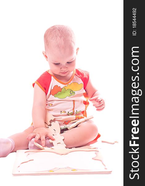 Sitting baby playing with toy isolated on white. Sitting baby playing with toy isolated on white