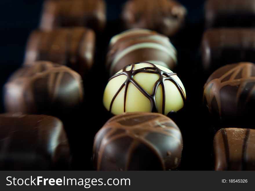 Delicious chocolates A white one is in sharp focus.