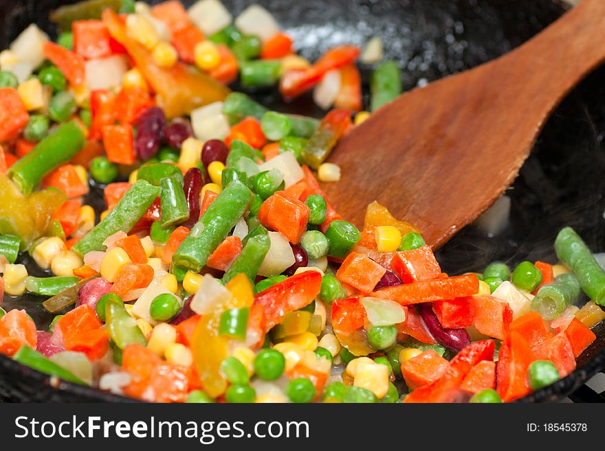 Chopped vegetables frying on a frying pan