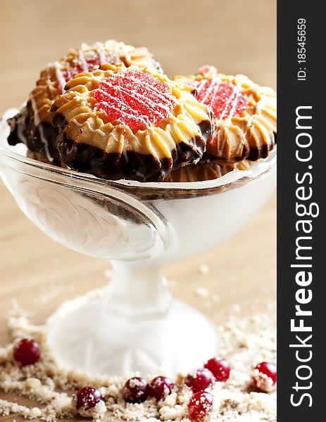 Butter cookie into a glass bowl on a wooden surface