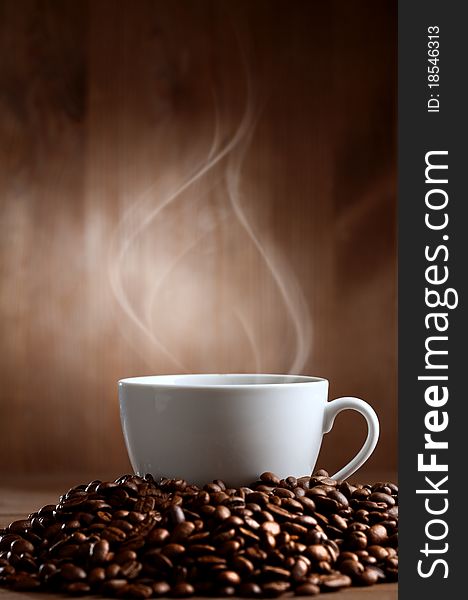 Warm cup of ciffee on brown background