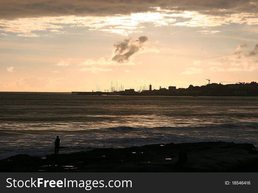 Fishing on a beautiful sunset in Estoril, Portugal