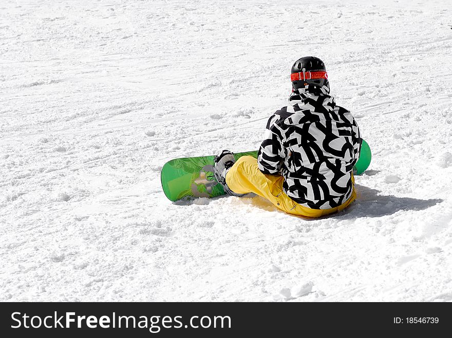 Young snowboarder with colored attire