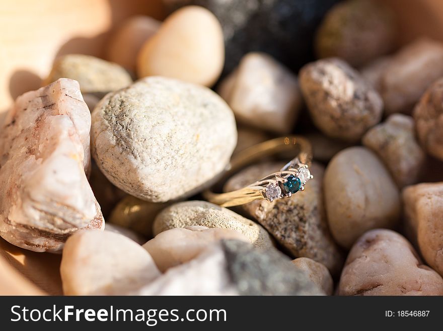 Blue diamond ring on sea stones