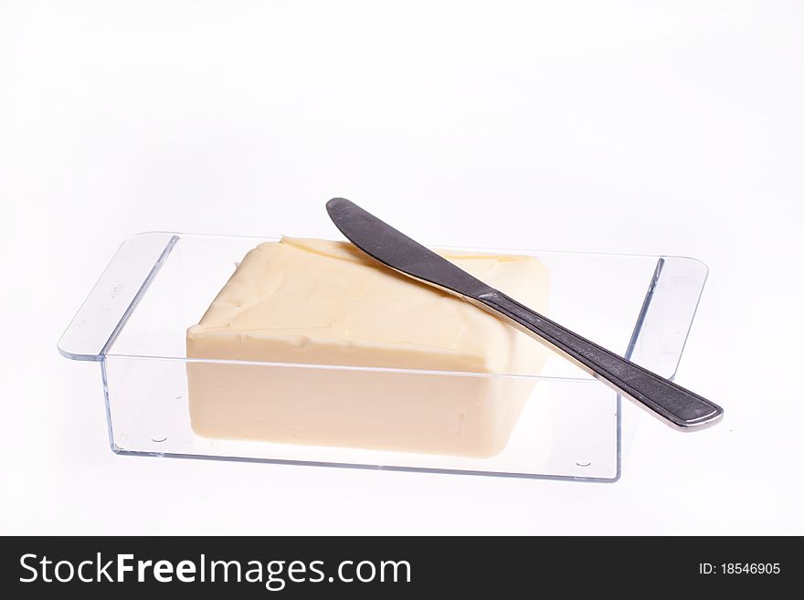 Open Block of Butter in butter dish with knife isolated over white. Open Block of Butter in butter dish with knife isolated over white