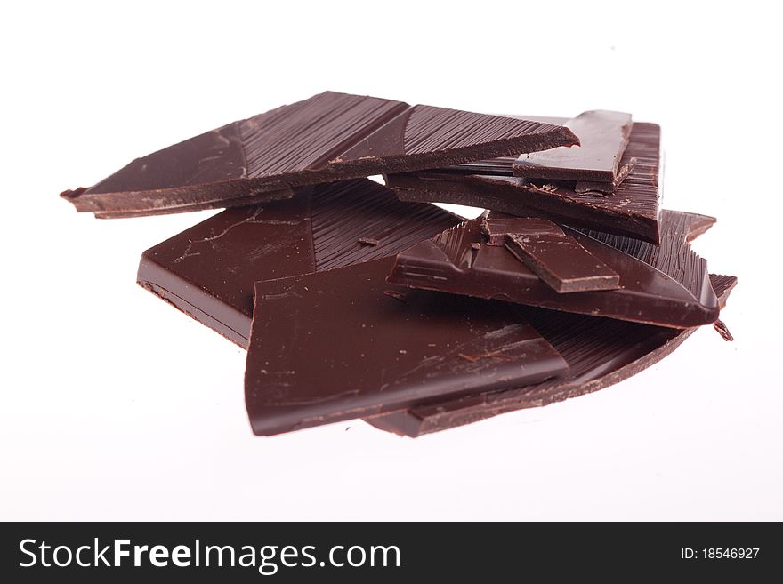 Chopped black chocolate over white background. Chopped black chocolate over white background