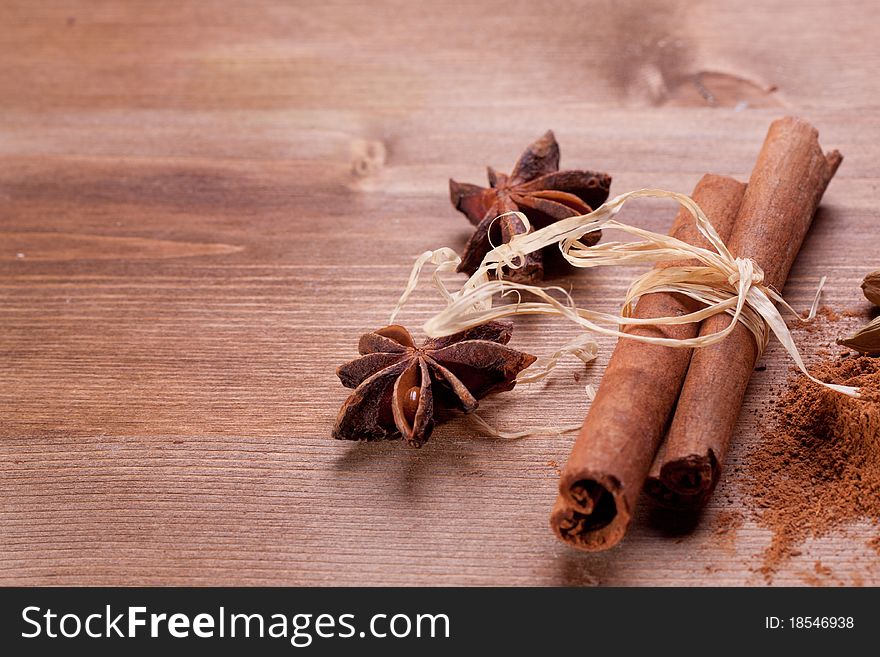 Mix of spice cinnamon and anise on wooden table