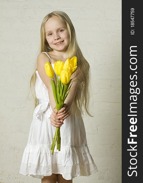 Young smiling girl with yellow flowers