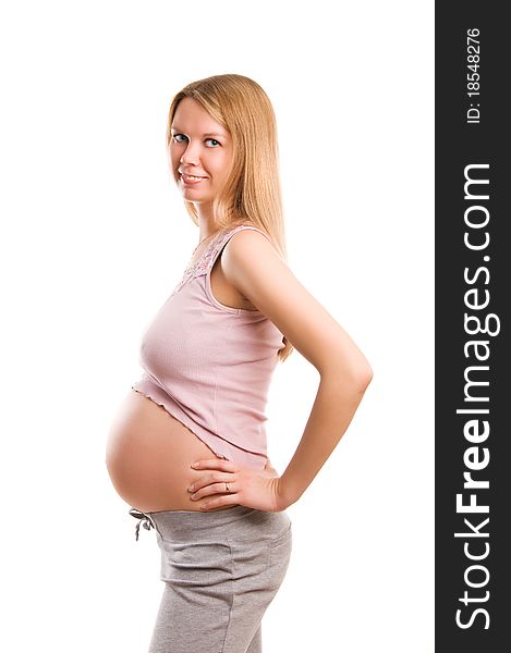 Beautiful young pregnant blond girl on white background
