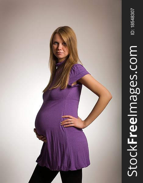 Beautiful young pregnant blonde girl