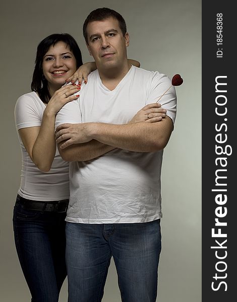 Love concept - man and woman on gray background. Love concept - man and woman on gray background