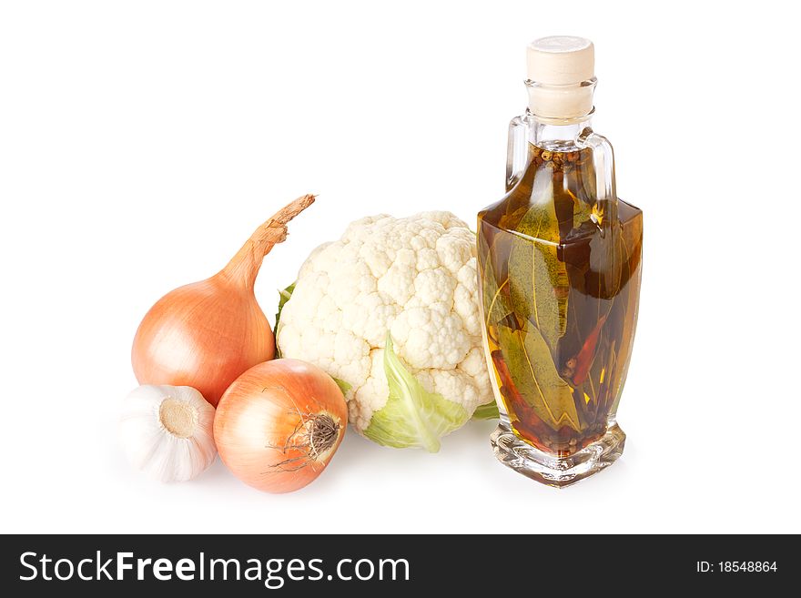 Vegetables and bottle of olive oil with spice