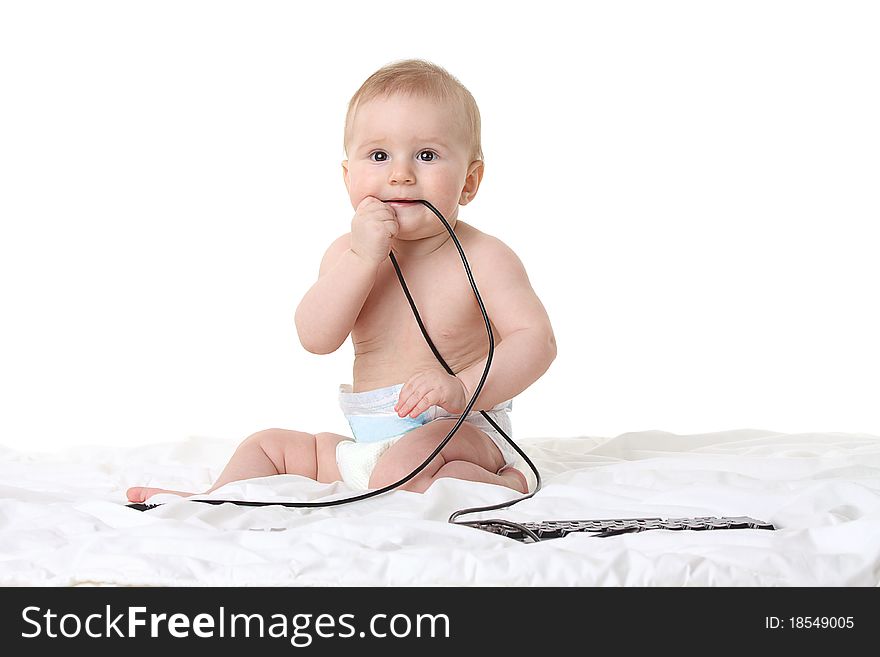 Little baby boy with a computer keyboard isolated on white