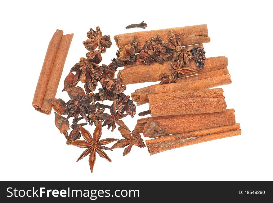 Spices consisting of star anise seeds, cinnamon, cloves and cardamon. They are all dried and isolated on white background.