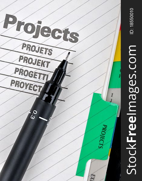 Project book page or document and a pen, shown as project woking and other business concept. Project book page or document and a pen, shown as project woking and other business concept.