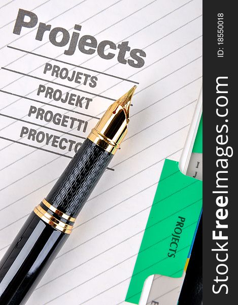 Project book page or document and a fountain pen, shown as project woking and other business concept. Project book page or document and a fountain pen, shown as project woking and other business concept.