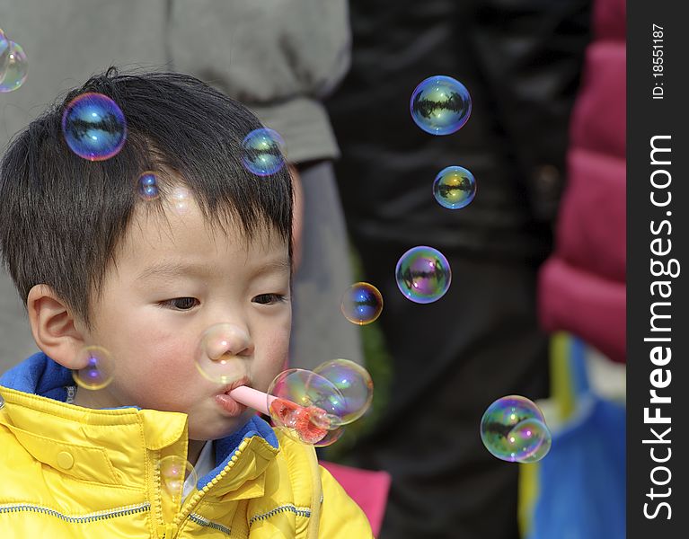 A child blowing soap bubbles. A child blowing soap bubbles