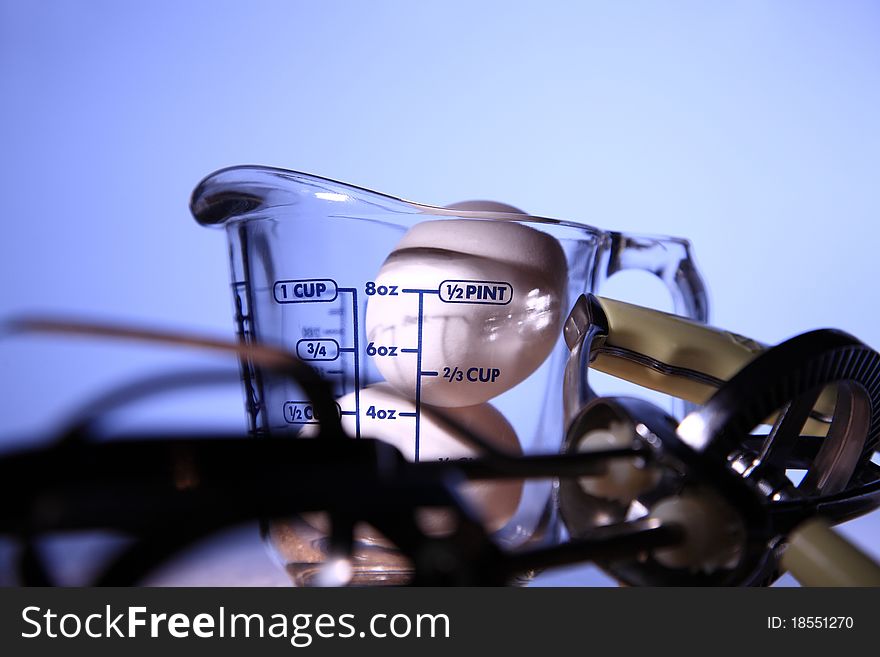 Two eggs in cup isolated with blue background