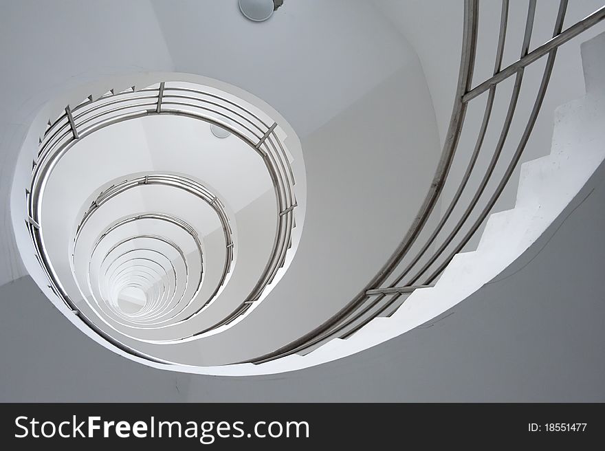White winding staircase inside a building