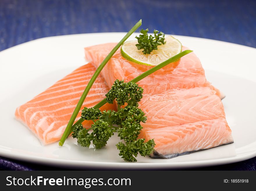Photo of delicious salmon fillet with parsley and lime. Photo of delicious salmon fillet with parsley and lime